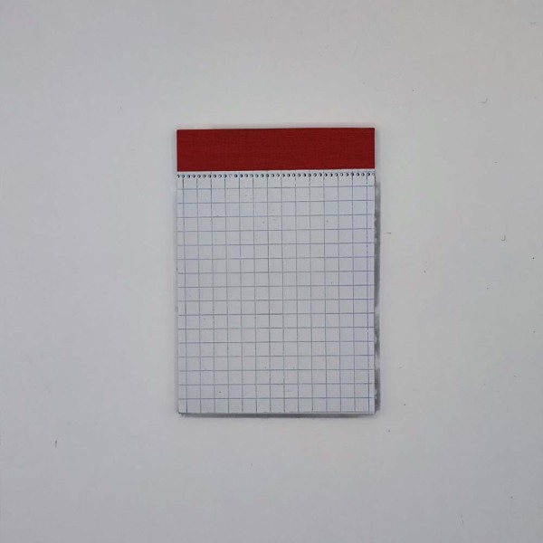 Jegyzettömb NYOMELL A/7 50 lapos kockás fejben sapkázott perforált